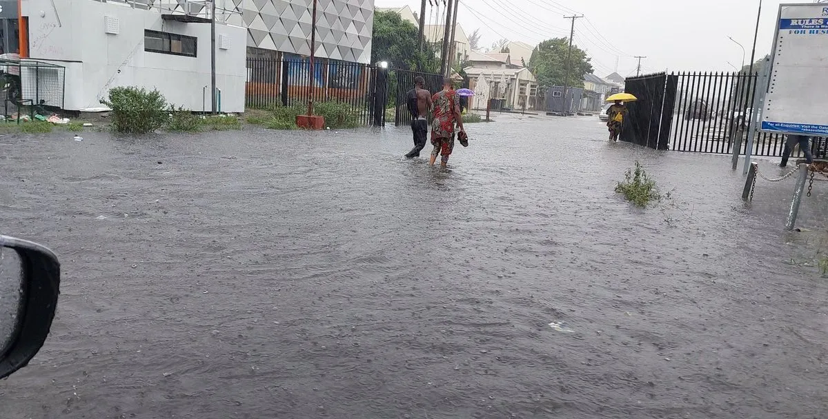 Boy swims in flooded road